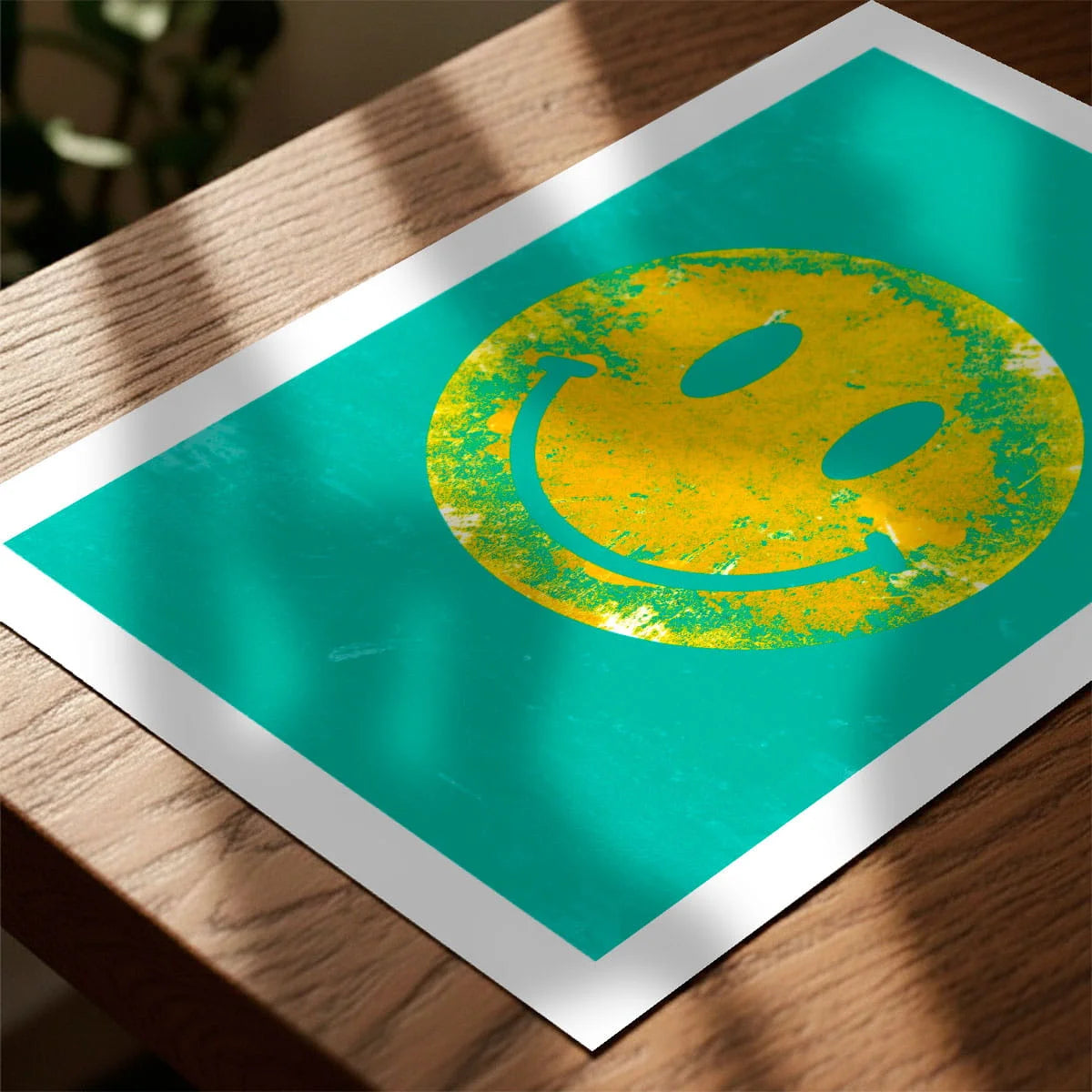 Print laying on table with speckled shade cast across the surface