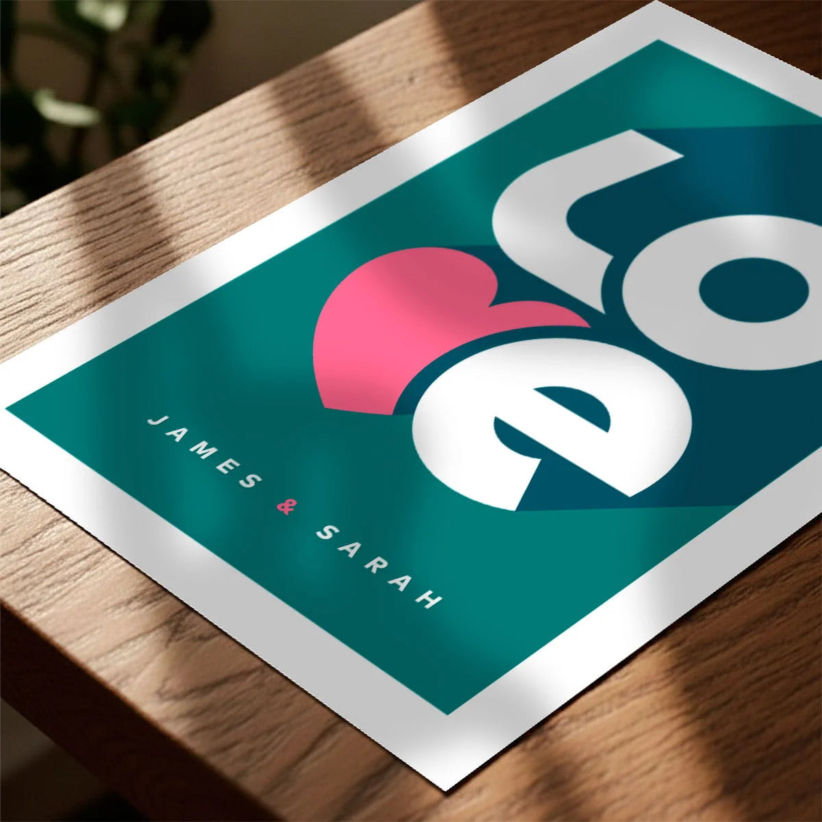 Print laying on table with speckled shade cast across the surface