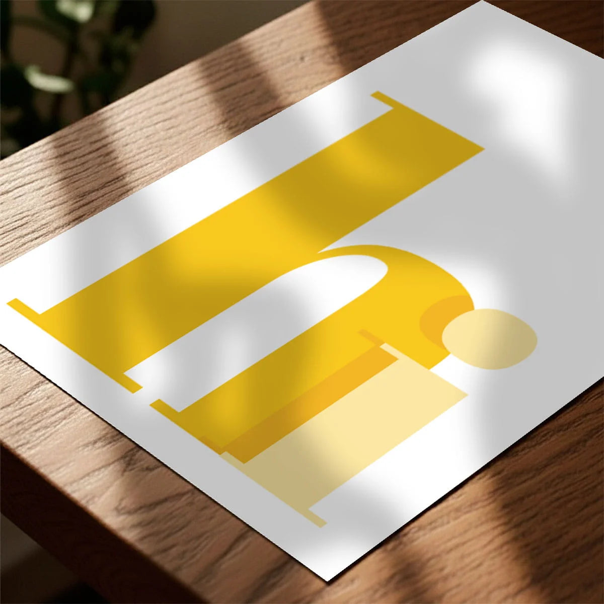 Print laying on table with speckled shade cast across the surface