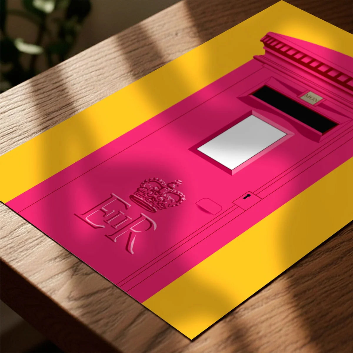 Print laying on table with speckled shade cast across the surface