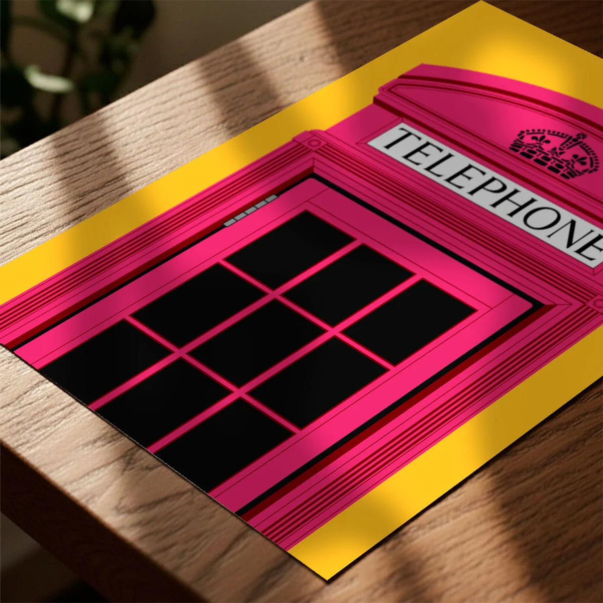 Print laying on table with speckled shade cast across the surface